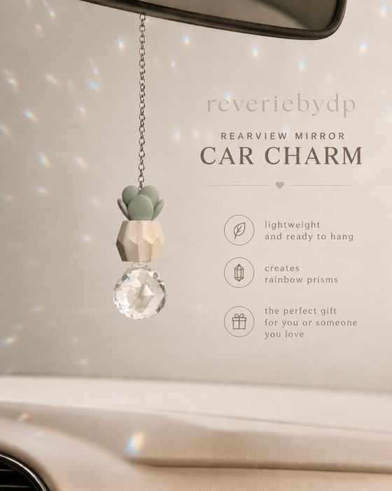 Plant car charm hanging from a rearview mirror