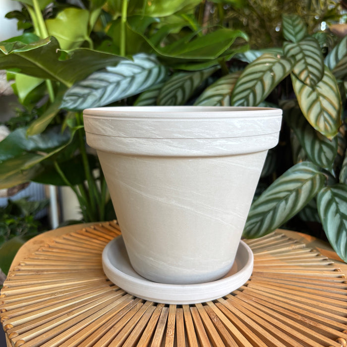 Empty light marble terracotta planter with saucer