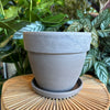 Empty rounded dark marble terracotta planter with saucer