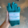 Hand holding teal plant cleaning gloves