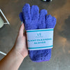 Hand holding purple plant cleaning gloves