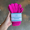 Hand holding magenta plant cleaning gloves