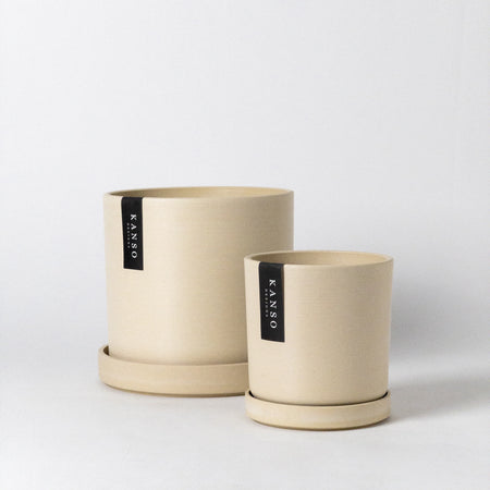 Two sand-coloured smooth finish planters with matching trays
