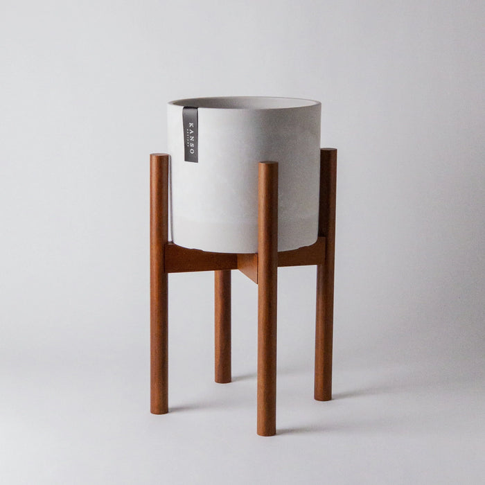 White planter on a medium stain bamboo plant stand
