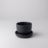 Empty small black bamboo fibre planter with saucer