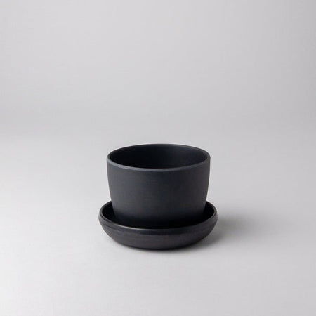 Empty small black bamboo fibre planter with saucer