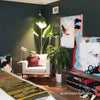 Aspect grow lights over plants in a dark-walled room
