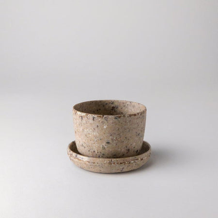 Empty small coffee bean husk planter with saucer