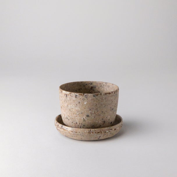 Empty small coffee bean husk planter with saucer